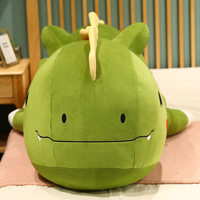 Peluche dinosaure avec logo cœur sur la joue