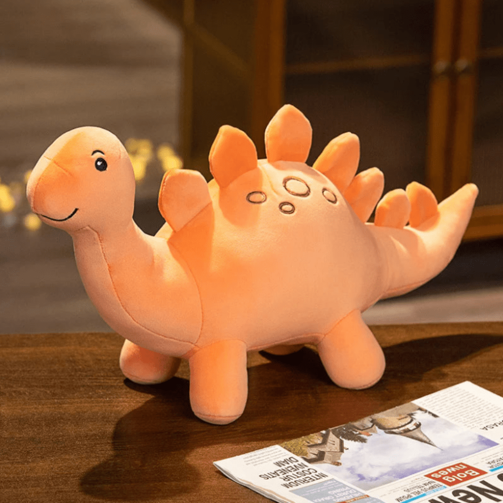 Peluche dinosaure orange à pointes sur le dos