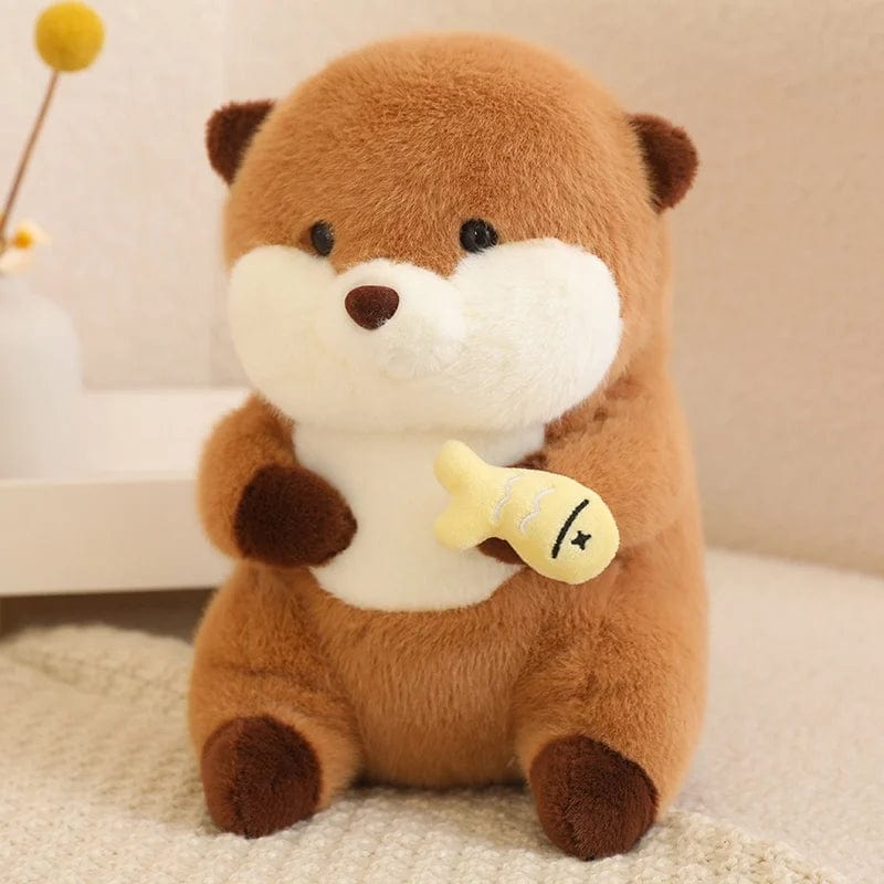 Peluche loutre avec un voile présentant un poisson coloré