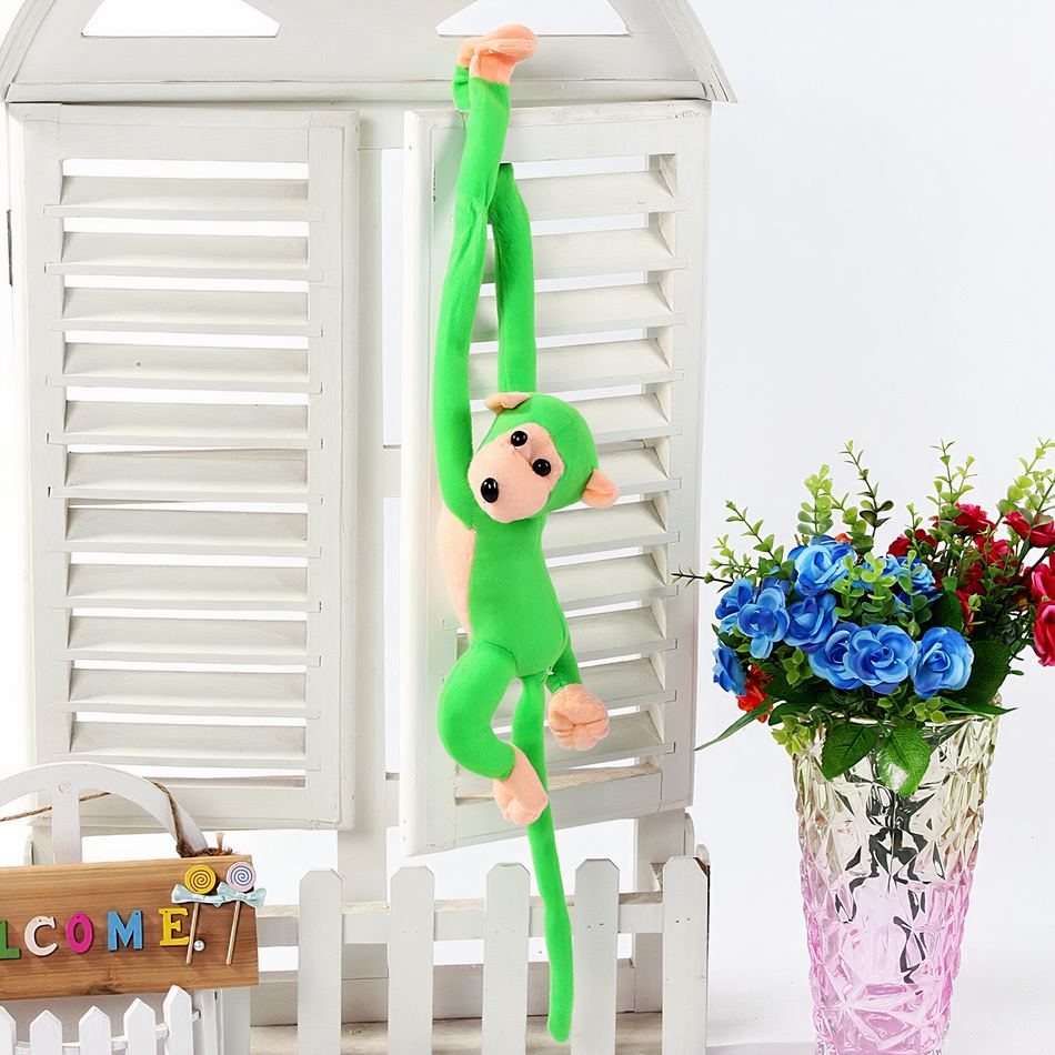 Peluche singe kawaii avec une longue queue verte de jungle.
