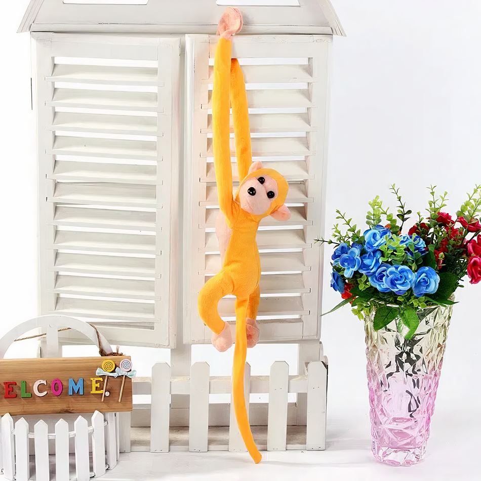 Peluche singe kawaii jaune avec une longue queue moelleuse pour enfant.